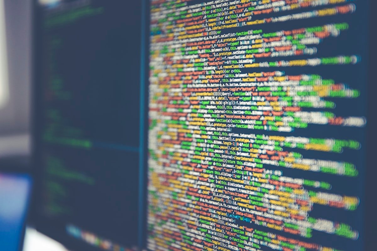 Security engineer reviewing code and logs on screen